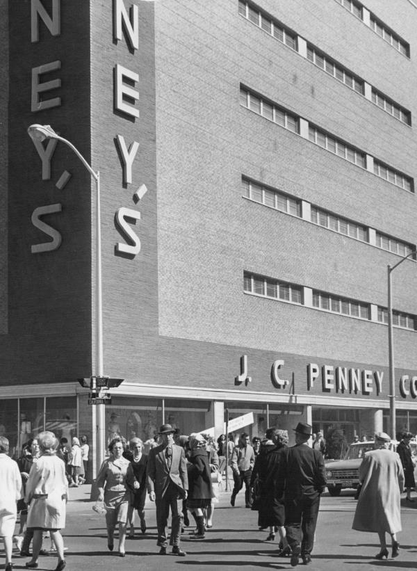 Shoppers hurry across an intersection in front of a JCPenney store in Denver in 1964.