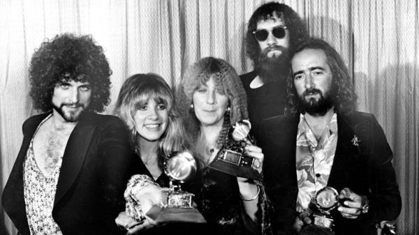 Fleetwood Mac, from left, Lindsey Buckingham, Stevie Nicks, Christine McVie, Mick Fleetwood, wearing sunglasses, and John McVie, pose with their Grammys at the annual Grammy Awards in Los Angeles in 1978