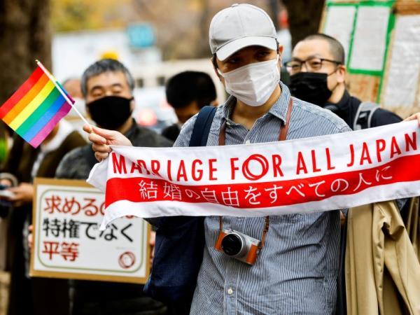 Supporters hold a banner that says 'Marriage for all Japan'