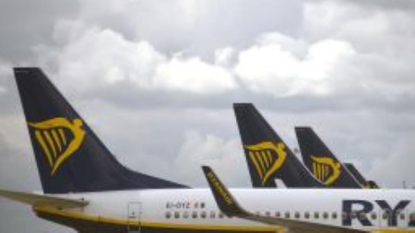 Aircraft grounded due to the COVID-19 pandemic, including planes operated by Ryanair, are pictured on the apron at Manchester Airport in Manchester, north west England on May 1, 2020. - Irish low-cost carrier Ryanair said on Friday it planned to axe 3,000 pilot and cabin crew jobs, or 15 percent of staff, with air transport paralysed by coronavirus. Dublin-based Ryanair added in a statement that most of its flights would remain grounded until at least July and predicted it would take until summer 2022 at the earliest before passenger demand recovers. (Photo by Oli SCARFF / AFP) (Photo by OLI SCARFF/AFP via Getty Images)