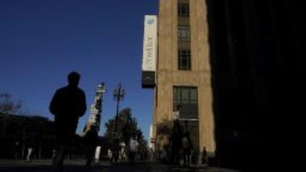 People walk outside of Twitter headquarters in San Francisco, Friday, Nov. 18, 2022. 