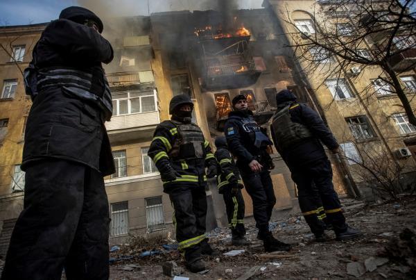 Firefighters work to put out a fire at a residential building hit by a Russian military strike in Bakhmut