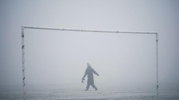 People walking on Hackney Marshes in London. Snow and ice have swept across parts of the UK, with cold wintry conditions set to continue for days. Picture date: Sunday December 11, 2022.