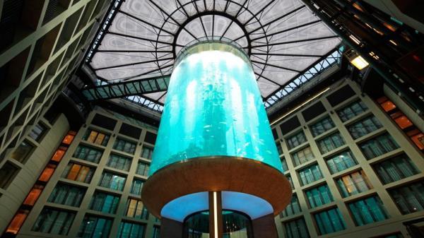 Atrium of the DomAquar��e Hotel with a massive aquarium in the middle. Berlin, Germany
