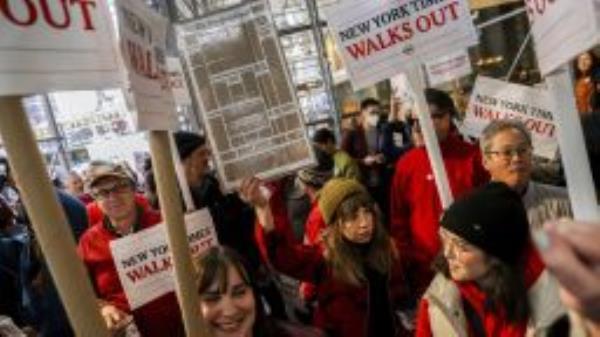 Hundreds of New York Times journalists and other staff protest outside the Times' office after walking off the job for 24 hours, frustrated by contract negotiations that have dragged on for months in the newspaper's biggest labor dispute in more than 40 years, Thursday, Dec. 8, 2022, in New York. 