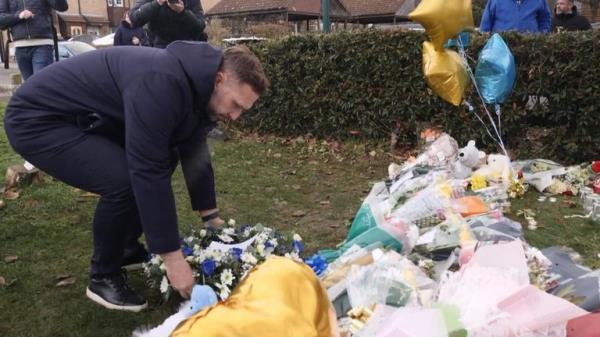 Birmingham City manager John Eustace lays a wreath for three boys who died after falling through a frozen lake in Solihull