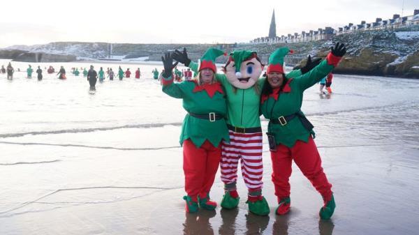 Cold water swimmers on the beach at Cullercoats Bay