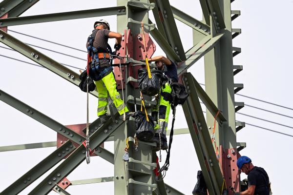 Specialists work at high voltage power lines in Germany
