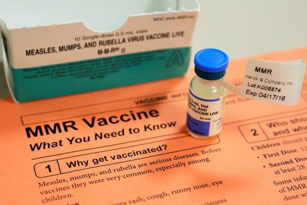 A vial of measles, mumps and rubella vaccine and an information sheet is seen at Boston Children's Hospital in Boston