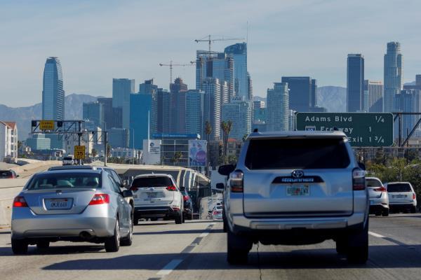 Traffic moves along a freeway as vehicles travel towards Los Angeles