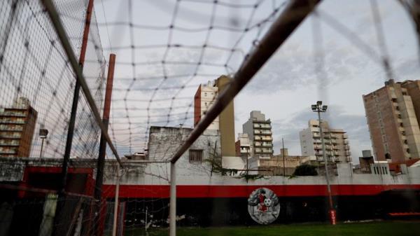 In this April 17, 2018 photo, a small mural depicting Lionel Messi as a child decorates the wall at a soccer field used by the Newell's Old Boys youth teams, Messi's childhood club, in Rosario, Argentina. Messi, born in Rosario, played for Rosario's local team before signing with Barcelona at age 13. The mural is the only sign that he was a standout player here as a child. (AP Photo/Natacha Pisarenko)