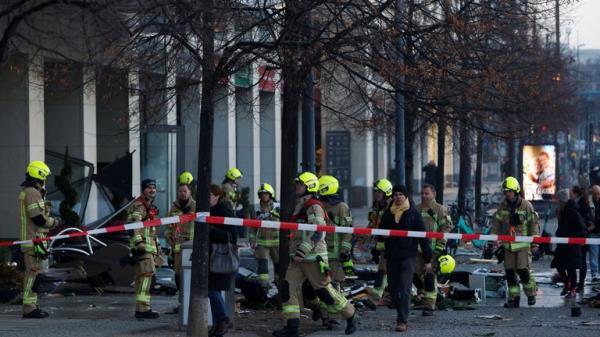 Emergency services work on a street outside a hotel after a leak of the AquaDom aquarium in central Berlin near Alexanderplatz, with water poured out onto the street, in Berlin, Germany, December 16, 2022. REUTERS/Michele Tantussi
