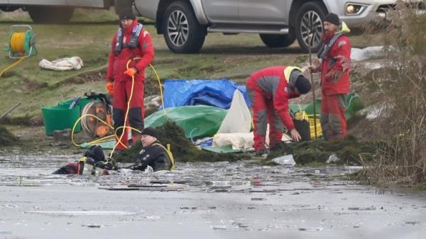 Police divers search the lake in Babbs Mill Park in Kingshurst, Solihull