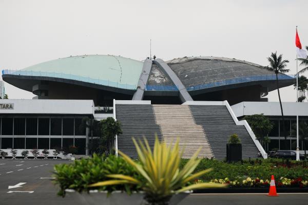 A worker walks on the roof of Indonesian Parliament Building in Jakarta