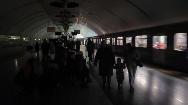 People shelter inside a metro station during partial power outage amid massive Russia's missile attacks in Kyiv, Ukraine