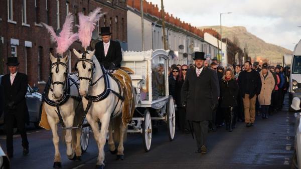 The horse-drawn carriage carrying the coffin of Stella-Lily McCorkindale through Belfast ahead of her funeral. Five-year-old Stella-Lily died after a case of Strep A was reported at the primary school she attended, Picture date: Wednesday December 14, 2022.
