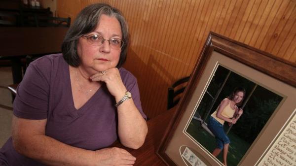 Wanda Farris sits beside a picture of her daughter, 16-year-old Leesa Gray. Pic: AP