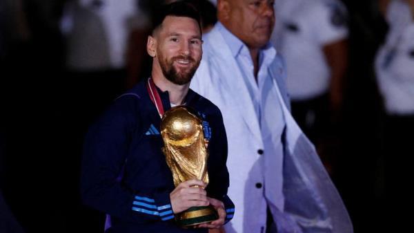  Lionel Messi with the trophy during the team's arrival. Pic: Reuters