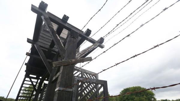 In this July 18, 2017 photo the wooden main gate leads into the former Nazi German Stutthof concentration camp in Sztutowo, Poland. A former SS guard is to go on trial in Germany on charges of accessory to murder for serving at the Nazis' Stutthof concentration camp. The 94-year-old, who hasn't been identified due to German privacy laws, is accused of working as a guard at the camp from June 1942 to the beginning of September 1944. (AP Photo/Czarek Sokolowski)


